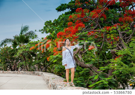 Beautiful woman on white dress walking alone at Beautiful woman on white dress walking alone at 53866780
