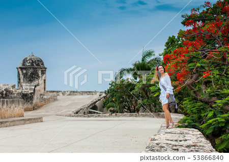 Beautiful woman on white dress walking alone at Beautiful woman on white dress walking alone at 53866840