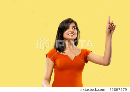 Portrait of beautiful woman isolated on yellow studio background Portrait of beautiful woman isolated on yellow studio background 53867379
