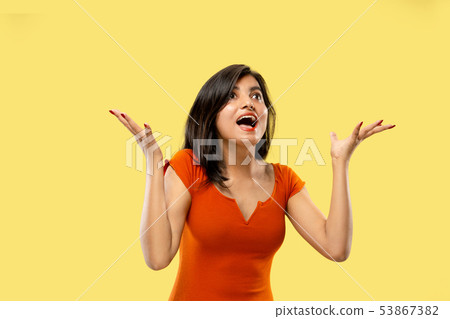 Portrait of beautiful woman isolated on yellow studio background 53867382