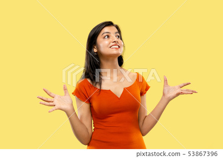 Portrait of beautiful woman isolated on yellow studio background 53867396