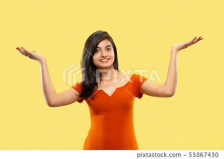 Portrait of beautiful woman isolated on yellow studio background Portrait of beautiful woman isolated on yellow studio background 53867430