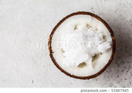 Coconut oil in a coconut shell on gray background, 53867985