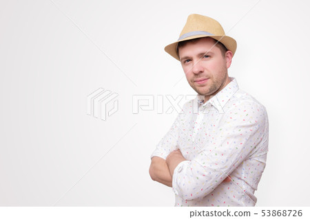Confident young man standing isolated over white Confident young man standing isolated over white 53868726