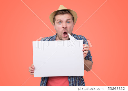 Angry man as tourist holds in his hand empty board 53868832