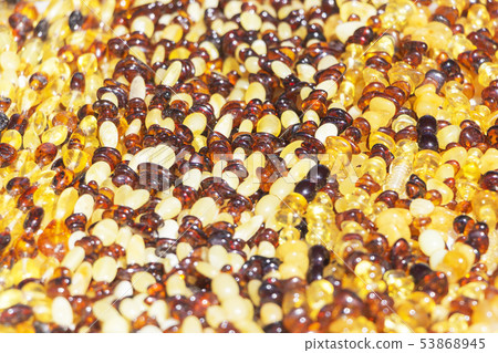 beads with amber, bright colorful pieces of amber. 53868945