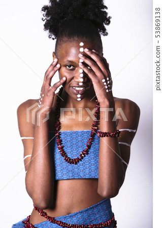 African girl with face art touching her face African girl with face art touching her face 53869138
