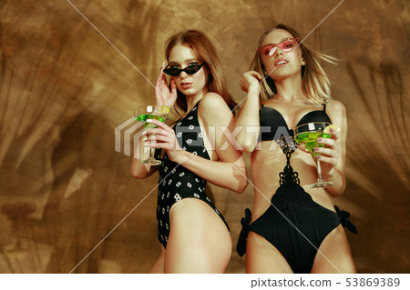 Beautiful girls isolated on braun studio background 53869389