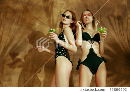 Beautiful girls isolated on braun studio background 53869392