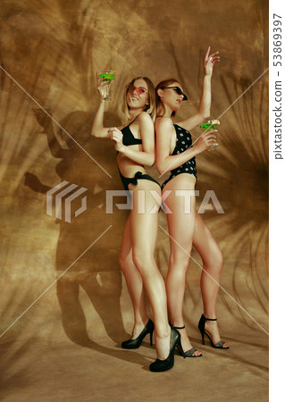 Beautiful girls isolated on braun studio background Beautiful girls isolated on braun studio background 53869397