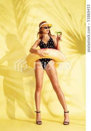 Beautiful girl isolated on yellow studio background Beautiful girl isolated on yellow studio background 53869455