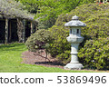 Spring garden with oriental grey stone lantern 53869496