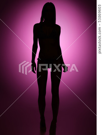 Full-length female silhouette on purple background 53869603