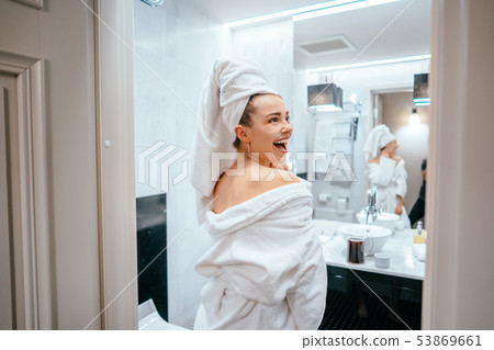 beauty portrait of pretty woman dressing a white bath towel 53869661
