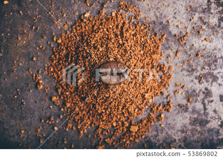 Coffee bean on heap of ground coffee Coffee bean on heap of ground coffee 53869802