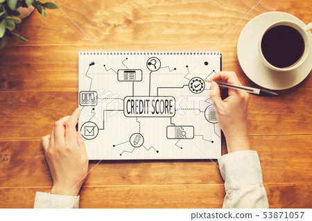 Credit score theme with a person writing in a notebook  Credit score theme with a person writing in a notebook  53871057