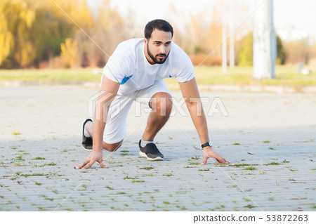 Healthy lifestyle. Fitness man doing exercise in city environment 53872263