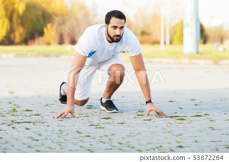 Healthy lifestyle. Fitness man doing exercise in city environment 53872264
