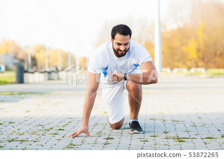 Healthy lifestyle. Fitness man doing exercise in city environment 53872265