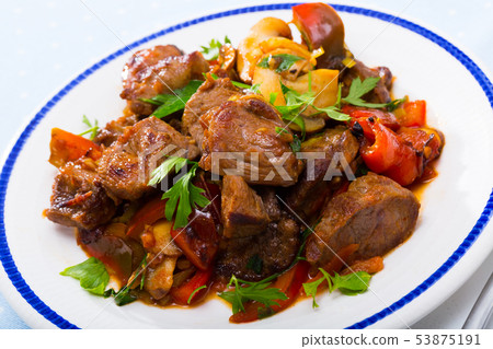 Cooked fried pork meat with peppers, mushrooms and greens Cooked fried pork meat with peppers, mushrooms and greens 53875191