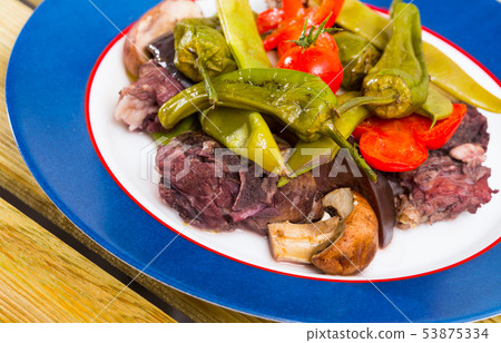 Tasty stewed lamb cooked with different vegetables served at plate Tasty stewed lamb cooked with different vegetables served at plate 53875334