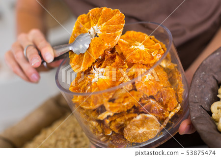 Illustration of container with dried orange 53875474