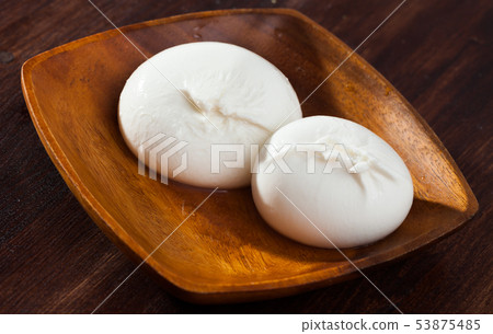 Burrata cheese and rukkola leaf closeup Burrata cheese and rukkola leaf closeup 53875485