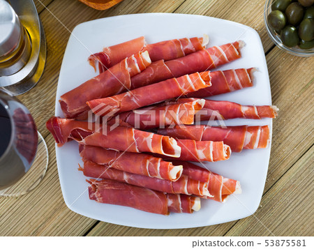 Rolled up slices of dry-cured ham 53875581