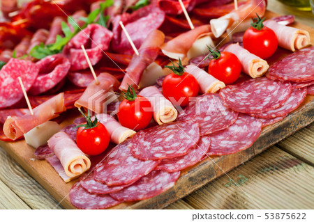 Spanish sausage cutting 53875622