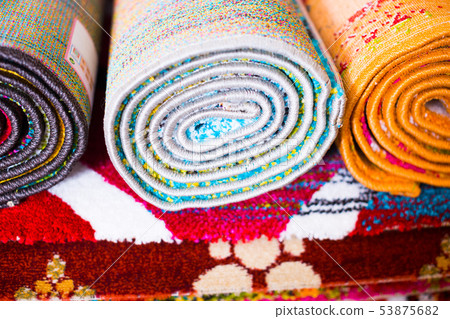 Stack of traditional colorful carpets in carpet shop Stack of traditional colorful carpets in carpet shop 53875682