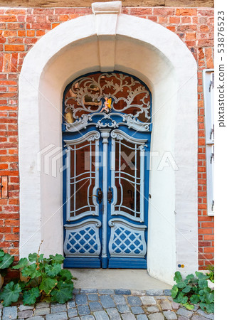 Old blue wooden front door in house. Luneburg. 53876523