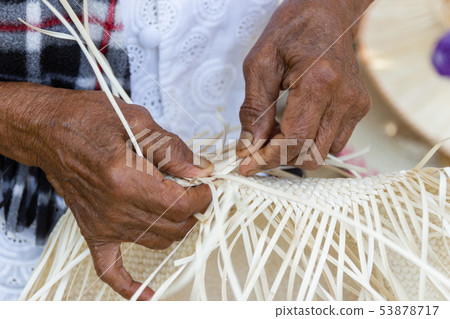 The villagers took bamboo stripes to weave 53878717