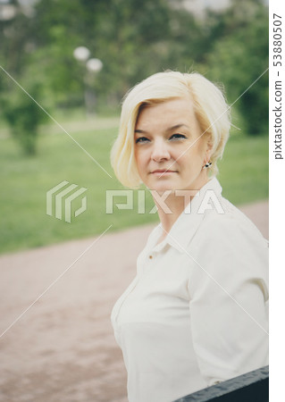 isolated photo: portrait of a smiling handsome woman in a business suit 53880507