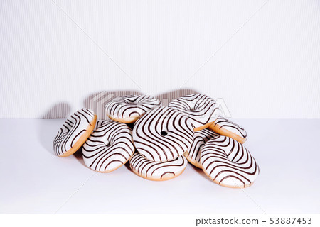 Striped donuts on a white background. 53887453