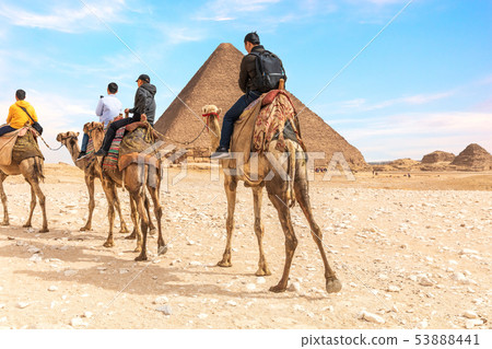 Tourists on camels near the Pyramids of Giza, Egypt 53888441