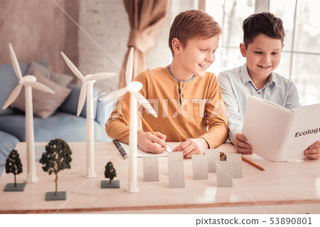 Two beaming schoolboys speaking about ecology Two beaming schoolboys speaking about ecology 53890801