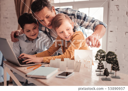 Foster father showing their children educational video 53890937