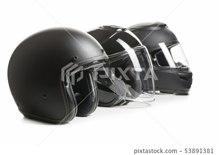 Three black motorcyle helmets. 53891381