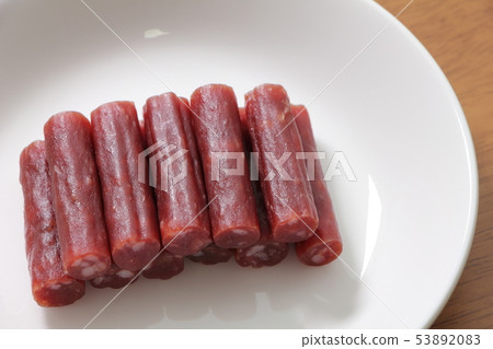 Dry sausage placed on a round plate. Dry sausage placed on a round plate. 53892083