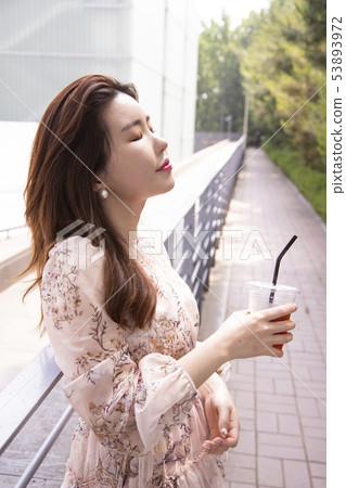 A woman drinking coffee 53893972