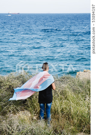 young person with a transgender pride flag 53894197