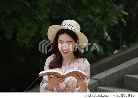 A woman reading A woman reading 53895910