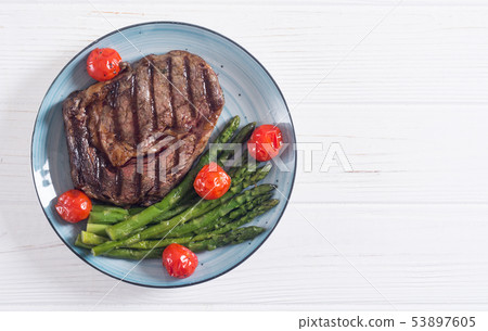 Grilled beef steak ribeye with cherry tomatoes and Grilled beef steak ribeye with cherry tomatoes and 53897605