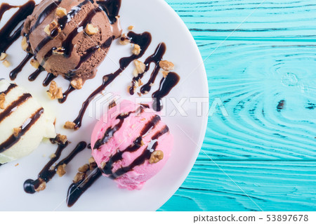 Ice cream with walnuts and chocolate topping Ice cream with walnuts and chocolate topping 53897678
