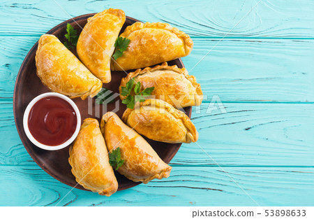 Latin American baked beef empanadas with sauce 53898633