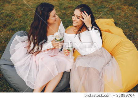Two pretty girls in a summer park Two pretty girls in a summer park 53899704