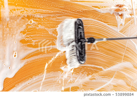 Brush leaving strokes in soap and foam on yellow Brush leaving strokes in soap and foam on yellow 53899884