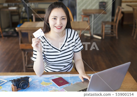 A young woman who plans to travel abroad A young woman who plans to travel abroad 53900154