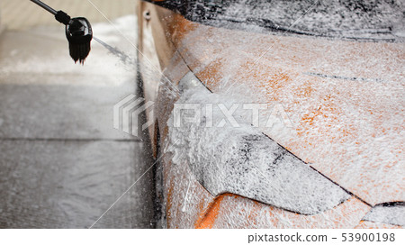 Car being washed at self service carwash. Foam and 53900198