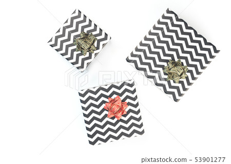 Black and white chevron gift boxes with green bows isolated Black and white chevron gift boxes with green bows isolated 53901277